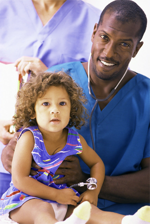 baby in purple dress being held by doctor