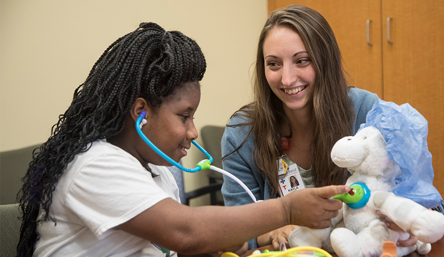 Child life with teddy bear stethoscope teaching