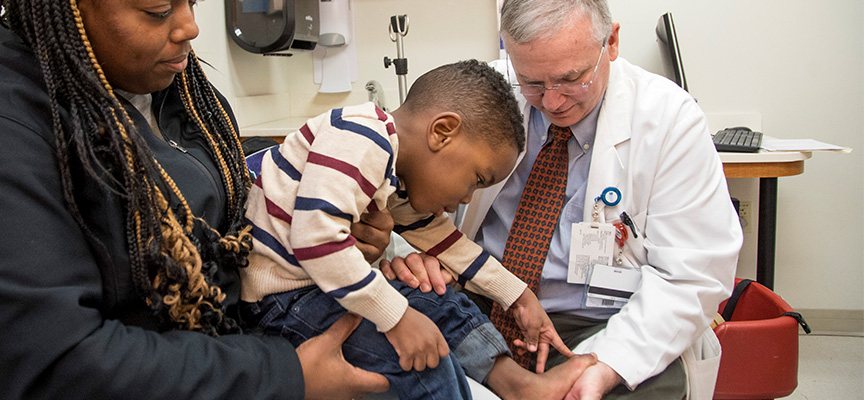 William Warner, MD with a Neuromuscular Clinic patient at Le Bonheur Children's Hospital