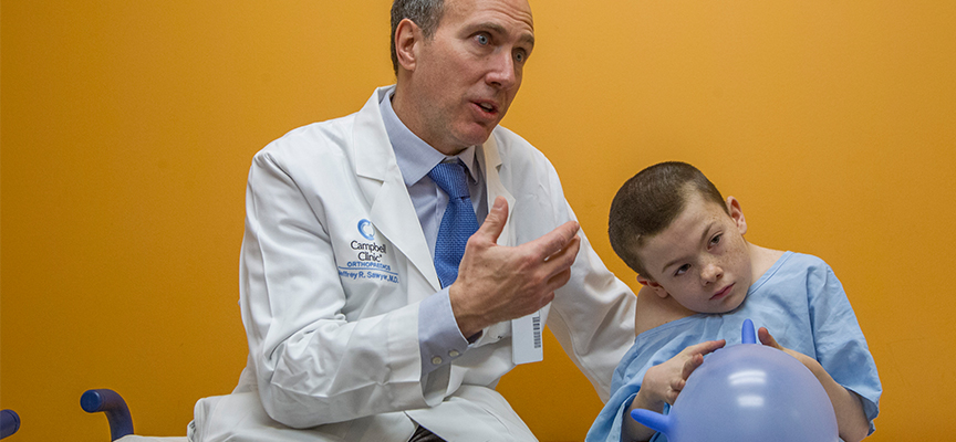 Jeffrey Sawyer, MD with a Scoliosis patient at Le Bonheur Children's Hospital