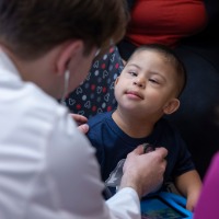 Child with Down Syndrome being cared for by doctor in ULPS Clinic